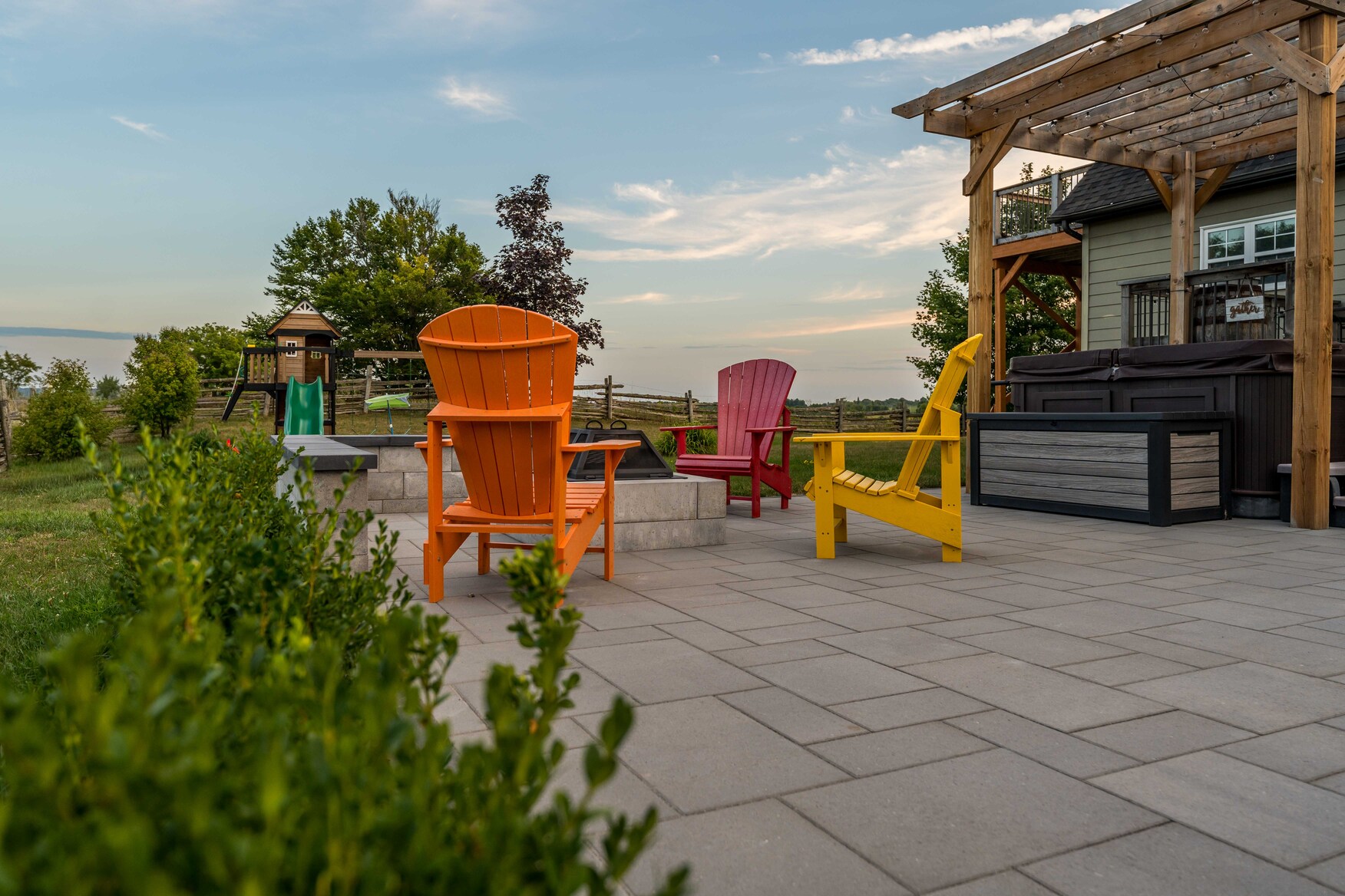 Stone Seating Area with Colourful Chairs Around Firepit