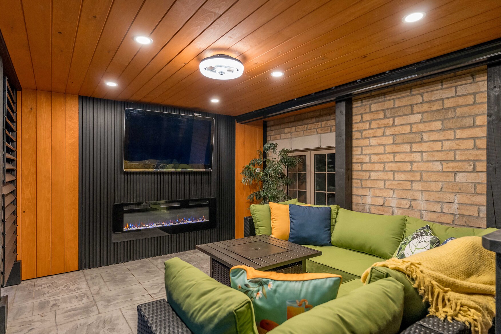 Covered Outdoor Living area with TV, Electric Fireplace and patio furniture